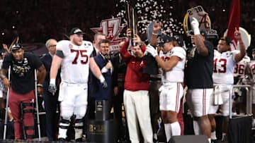 ATLANTA, GA - JANUARY 08: Head coach Nick Saban of the Alabama Crimson Tide holds the trophy while celebrating with his team after defeating the Georgia Bulldogs in overtime to win the CFP National Championship presented by AT