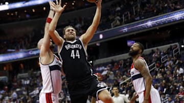 Apr 6, 2016; Washington, DC, USA; Brooklyn Nets guard Bojan Bogdanovic (44) shoots the ball as Washington Wizards center Marcin Gortat (13) defends in the third quarter at Verizon Center. The Wizards won 121-103. Mandatory Credit: Geoff Burke-USA TODAY Sports