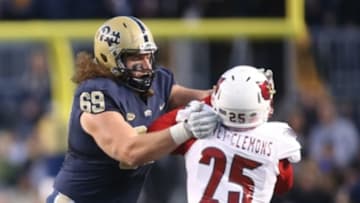 Nov 21, 2015; Pittsburgh, PA, USA; Pittsburgh Panthers offensive lineman Adam Bisnowaty (69) blocks against Louisville Cardinals safety Josh Harvey-Clemons (25) during the second quarter at Heinz Field. PITT won 45-34. Mandatory Credit: Charles LeClaire-USA TODAY Sports