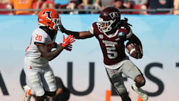 Jan 2, 2023; Tampa, FL, USA; Mississippi State Bulldogs wide receiver Lideatrick Griffin (5) stiff arms Illinois Fighting Illini defensive back Tyler Strain (20) during the second half in the 2023 ReliaQuest Bowl at Raymond James Stadium. Mandatory Credit: Kim Klement-USA TODAY Sports