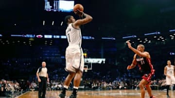 May 10, 2014; Brooklyn, NY, USA; Brooklyn Nets guard Joe Johnson (7) shoots for three over Miami Heat forward Shane Battier (31) during the third quarter in game three of the second round of the 2014 NBA Playoffs at Barclays Center. Brooklyn Nets won 104-90. Mandatory Credit: Anthony Gruppuso-USA TODAY Sports