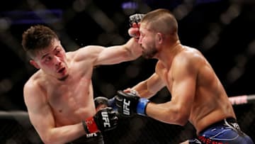 HOUSTON, TEXAS - FEBRUARY 12: Mana Martinez (L) exchanges strikes with Ronnie Lawrence in their bantamweight fight during UFC 271 at Toyota Center on February 12, 2022 in Houston, Texas. (Photo by Carmen Mandato/Getty Images)