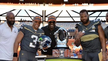 Jan 31, 2016; Honolulu, HI, USA; Team Irvin quarterback Russell Wilson (3) and defensive end Michael Bennett (72) of the Seattle Seahawks pose with Michael Irvin (second from right) and Jerry Rice (right) after being selected as the offensive and defensive players of the game during the 2016 Pro Bowl at Aloha Stadium. Mandatory Credit: Kirby Lee-USA TODAY Sports