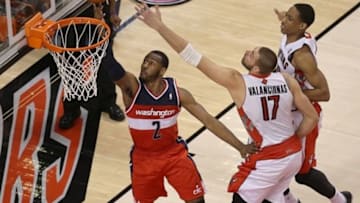 Feb 27, 2014; Toronto, Ontario, CAN; Washington Wizards guard John Wall (10) ties the game by scoring on a lay-up late in the first overtime period against the Toronto Raptors at Air Canada Centre. The Wizards beat the Raptors 134-129 in triple overtime. Mandatory Credit: Tom Szczerbowski-USA TODAY Sports