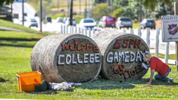 Catherine Garrison Davis, Clemson University class of 1995, of Anderson paints two hay bales with "Welcome ESPN College Gameday" in front of the Denver Downs farm along Clemson Boulevard Monday, September 26, 2022. Clemson football plays a 7:30 p.m. game in Memorial Stadium with ACC conference rival North Carolina State, a game which television network ESPN will set up a stage on Bowman Field on campus for the Tigers' eighth College Gameday appearance.Denver Downs College Gameday Display