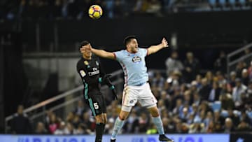 VIGO, SPAIN - JANUARY 07: Maxi Gomez of RC Celta de Vigo competes for the ball with Raphael Varane of Real Madrid during the La Liga match between RC Celta de Vigo and Real Madrid at Municipal Balaidos on January 7, 2018 in Vigo, . (Photo by Octavio Passos/Getty Images)