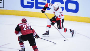 Nov 28, 2015; Glendale, AZ, USA; Ottawa Senators left wing Mike Hoffman (68) shoots the puck as Arizona Coyotes defenseman Oliver Ekman-Larsson (23) defends during the third period at Gila River Arena. Mandatory Credit: Matt Kartozian-USA TODAY Sports