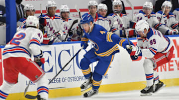 Jan 28, 2021; Buffalo, New York, USA; Buffalo Sabres left wing Taylor Hall (4) skates with the puck between New York Rangers defenseman Brendan Smith (42) and right wing Pavel Buchnevich (89) in the second period at KeyBank Center. Mandatory Credit: Mark Konezny-USA TODAY Sports