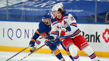 BUFFALO, NY - JANUARY 26: Artemi Panarin #10 of the New York Rangers skates up ice with the puck as Tobias Rieder #13 of the Buffalo Sabres pursues during the second period at KeyBank Center on January 26 , 2021 in Buffalo, New York. (Photo by Kevin Hoffman/Getty Images)