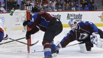 Nov 20, 2014; Denver, CO, USA; Washington Capitals left wing Alex Ovechkin (left) scores against Colorado Avalanche defenseman Jan Hejda (center) and goalie Reto Berra (20) during the third period at Pepsi Center. The Capitals won 3-2. Mandatory Credit: Chris Humphreys-USA TODAY Sports