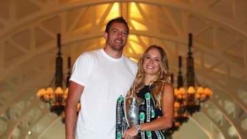 SINGAPORE - OCTOBER 30: Champion Caroline Wozniacki of Denmark poses with the Billie Jean King trophy and American professional basketball player David Lee after her victory against Venus Williams of the United States in the final of the BNP Paribas WTA Finals Singapore presented by SC Global at Clifford Pier on October 30, 2017 in Singapore. (Photo by Clive Brunskill/Getty Images)