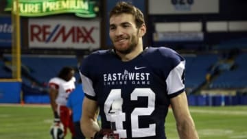 Jan 23, 2016; St. Petersburg, FL, USA; West Team safety Mike Caputo (42) holds a trophy as the defensive MVP half of the East-West Shrine Game at Tropicana Field. West Team beat the East Team 29-9. Mandatory Credit: Kim Klement-USA TODAY Sports