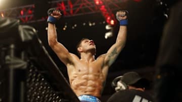 Mar 14, 2015; Dallas, TX, USA; Rafael dos Anjos (blue) reacts after defeating Anthony Pettis (red) in the lightweight title bout during UFC 185 at American Airlines Center. Mandatory Credit: Tim Heitman-USA TODAY Sports