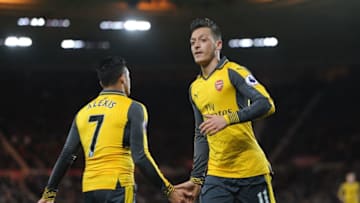 MIDDLESBROUGH, ENGLAND - APRIL 17: Mesut Ozil high fives Alexis Sanchez of Arsenal during the Premier League match between Middlesbrough and Arsenal at Riverside Stadium on April 17, 2017 in Middlesbrough, England. (Photo by David Price/Arsenal FC via Getty Images)