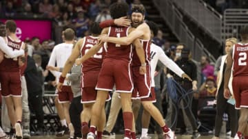 Mar 10, 2022; Kansas City, MO, USA; Oklahoma Sooners center Tanner Groves (35) hugs teammate Oklahoma Sooners forward Jalen Hills (1) after defeating the Baylor Bears at T-Mobile Center. Mandatory Credit: Amy Kontras-USA TODAY Sports