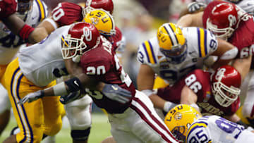 NEW ORLEANS - JANUARY 4: Running back Kejuan Jones #20 of the Oklahoma Sooners is tackled during the game against the Louisiana State Tigers in the Nokia Sugar Bowl National Championship on January 4, 2004 at the Louisiana Superdome in New Orleans, Louisiana. The LSU Tigers defeated the Oklahoma Sooners 21-14 to win the National Championship. (Photo by Andy Lyons/Getty Images)