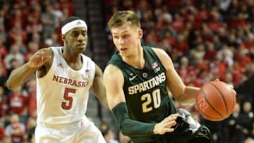 LINCOLN, NE - JANUARY 17: Matt McQuaid #20 of the Michigan State Spartans drives against Glynn Watson Jr. #5 of the Nebraska Cornhuskers at Pinnacle Bank Arena on January 17, 2019 in Lincoln, Nebraska. (Photo by Steven Branscombe/Getty Images)