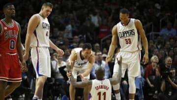 Jan 31, 2016; Los Angeles, CA, USA; Los Angeles Clippers guard Jamal Crawford (11) celebrates with guard Pablo Prigioni (L) and forward Wesley Johnson (R) after scoring during the fourth quarter against the Chicago Bulls at Staples Center. The Los Angeles Clippers won 120-93. Mandatory Credit: Kelvin Kuo-USA TODAY Sports