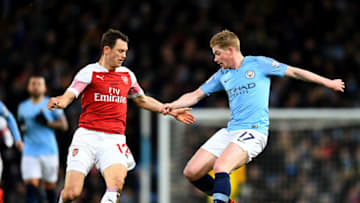 MANCHESTER, ENGLAND - FEBRUARY 03: Kevin De Bruyne of Manchester City is challenged by Stephan Lichtsteiner of Arsenal during the Premier League match between Manchester City and Arsenal FC at Etihad Stadium on February 03, 2019 in Manchester, United Kingdom. (Photo by Clive Mason/Getty Images)