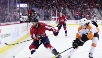 WASHINGTON, DC - JANUARY 21: Brett Connolly #10 of the Washington Capitals and Nolan Patrick #19 of the Philadelphia Flyers battle for the puck in the first period at Capital One Arena on January 21, 2018 in Washington, DC. (Photo by Patrick McDermott/NHLI via Getty Images)
