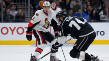 Jan 16, 2016; Los Angeles, CA, USA; Los Angeles Kings left wing Dwight King (74) takes the puck down ice as Ottawa Senators defenseman Cody Ceci (5) defends in the third period of the game at Staples Center. Senators won 5-3. Mandatory Credit: Jayne Kamin-Oncea-USA TODAY Sports