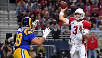 Dec 6, 2015; St. Louis, MO, USA; Arizona Cardinals quarterback Carson Palmer (3) attempts a pass under pressure from St. Louis Rams defensive tackle Aaron Donald (99) during the first half at the Edward Jones Dome. Mandatory Credit: Jasen Vinlove-USA TODAY Sports