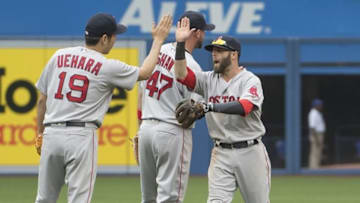 May 29, 2016; Toronto, Ontario, CAN; Boston Red Sox relief pitcher Koji Uehara (19) celebrates the win with second baseman Dustin Pedroia (15) at the end of the eleventh inning in a game against the Toronto Blue Jays at Rogers Centre. The Boston Red Sox won 5-3. Mandatory Credit: Nick Turchiaro-USA TODAY Sports