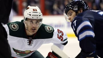 Dec 29, 2014; Winnipeg, Manitoba, CAN; Winnipeg Jets forward Adam Lowry (17) faces off against Minnesota Wild forward Tyler Graovac (53) during the third period at MTS Centre. The Wild won 3-2. Mandatory Credit: Bruce Fedyck-USA TODAY Sports