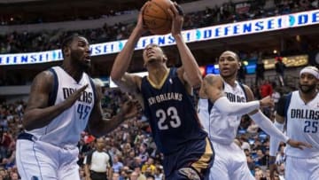 Feb 26, 2014; Dallas, TX, USA; New Orleans Pelicans power forward Anthony Davis (23) drives to the basket past Dallas Mavericks center DeJuan Blair (45) and small forward Shawn Marion (0) during the first half at the American Airlines Center. Mandatory Credit: Jerome Miron-USA TODAY Sports