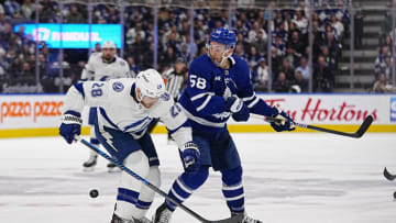 Apr 18, 2023; Toronto, Ontario, CAN; Tampa Bay Lightning defenseman Ian Cole (28) and Toronto Maple Leafs forward Michael Bunting (58) battle for the puck during the first period of game one of the first round of the 2023 Stanley Cup Playoffs at Scotiabank Arena. Mandatory Credit: John E. Sokolowski-USA TODAY Sports