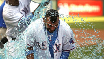 ARLINGTON, TX - JUNE 17: Jose Trevino #71 of the Texas Rangers is doused by teammates after he hit a game winning two-run single against the Colorado Rockies in the bottom of the ninth inning at Globe Life Park in Arlington on June 17, 2018 in Arlington, Texas. The Rangers won 13-12. (Photo by Ron Jenkins/Getty Images)