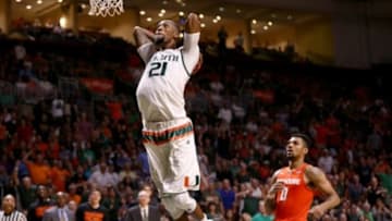 Jan 2, 2016; Coral Gables, FL, USA; Miami Hurricanes forward Kamari Murphy (21) dunks the ball as Syracuse Orange forward Michael Gbinije (0) looks on during the second half at BankUnited Center. Miami won 64-51. Mandatory Credit: Steve Mitchell-USA TODAY Sports
