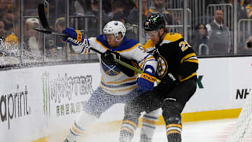 Mar 2, 2023; Boston, Massachusetts, USA; Boston Bruins defenseman Brandon Carlo (25) rides Buffalo Sabres left wing Jeff Skinner (53) into the boards during the second period at TD Garden. Mandatory Credit: Winslow Townson-USA TODAY Sports