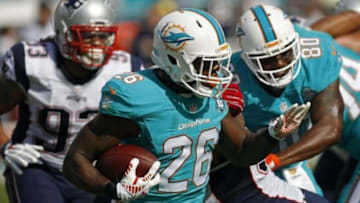 Jan 3, 2016; Miami Gardens, FL, USA; Miami Dolphins running back Lamar Miller (26) in the first half against the New England Patriots at Sun Life Stadium. Mandatory Credit: Andrew Innerarity-USA TODAY Sports