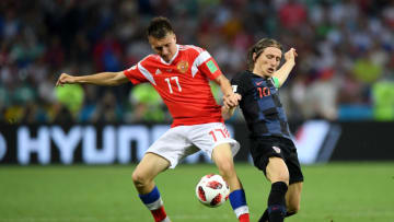 SOCHI, RUSSIA - JULY 07: Luka Modric of Croatia is challenged by Aleksandr Golovin of Russia during the 2018 FIFA World Cup Russia Quarter Final match between Russia and Croatia at Fisht Stadium on July 7, 2018 in Sochi, Russia. (Photo by Shaun Botterill/Getty Images)