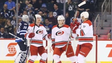 Feb 5, 2016; Winnipeg, Manitoba, CAN; Carolina Hurricanes right wing Andrej Nestrasil (15) celebrates his goal with teammates during the first period against the Winnipeg Jets at MTS Centre. Mandatory Credit: Bruce Fedyck-USA TODAY Sports