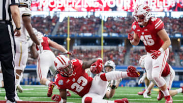 ARLINGTON, TX - JANUARY 2: Wisconsin Badgers running back Dare Ogunbowale (No. 23) falls in to the end zone for a touchdown during the Cotton Bowl matchup between the Western Michigan Broncos and the Wisconsin Badgers on January 2, 2017 at AT&T Stadium in Arlington, TX. Wisconsin won the game 24-16. (Photo by Matthew Visinsky/Icon Sportswire via Getty Images).