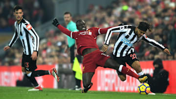 LIVERPOOL, ENGLAND - MARCH 03: Deandre Yedlin of Newcastle United is tackled by Sadio Mane of Liverpool during the Premier League match between Liverpool and Newcastle United at Anfield on March 3, 2018 in Liverpool, England. (Photo by Gareth Copley/Getty Images)