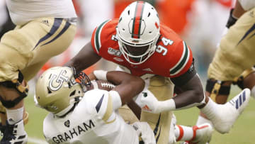 MIAMI, FLORIDA - OCTOBER 19: Trevon Hill #94 of the Miami Hurricanes sacks James Graham #4 of the Georgia Tech Yellow Jackets during the first half at Hard Rock Stadium on October 19, 2019 in Miami, Florida. (Photo by Michael Reaves/Getty Images)