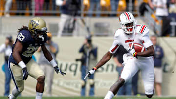PITTSBURGH, PA - OCTOBER 13: DeVante Parker #9 of the Louisville Cardinals runs after the catch against Lafayette Pitts #23 of the Pittsburgh Panthers during the game on October 13, 2012 at Heinz Field in Pittsburgh, Pennsylvania. The Cardinals defeated the Panthers 45-35. (Photo by Justin K. Aller/Getty Images)