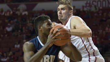 NORMAN, OK - DECEMBER 12: Ryan Spangler #00 of the Oklahoma Sooners tries to block Brandon Conley #5 of the Oral Roberts Golden Eagles during the first half of NCAA college basketball game at the Lloyd Noble Center on December 12, 2015 in Norman, Oklahoma. (Photo by J Pat Carter/Getty Images)
