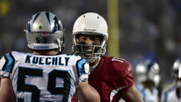 Jan 3, 2015; Charlotte, NC, USA; Arizona Cardinals wide receiver Larry Fitzgerald (11) talks to Carolina Panthers middle linebacker Luke Kuechly (59) during the second quarter in the 2014 NFC Wild Card playoff football game at Bank of America Stadium. Mandatory Credit: Bob Donnan-USA TODAY Sports