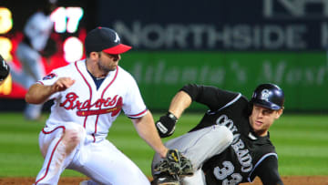 ATLANTA, GA - MAY 23: Justin Morneau #33 of the Colorado Rockies slides in to second base for an 8th inning double against Dan Uggla #26 of the Atlanta Braves at Turner Field on May 23, 2014 in Atlanta, Georgia. (Photo by Scott Cunningham/Getty Images)
