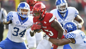 Nov 26, 2016; Louisville, KY, USA; Louisville Cardinals running back Brandon Radcliff (23) runs the ball against Kentucky Wildcats linebacker Courtney Love (51) and linebacker Jordan Jones (34) during the second half at Papa John