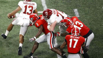 ATLANTA, GA - JANUARY 08: Quarterback Tua Tagovailoa #13 of the Alabama Crimson Tide escapes the grasp of linebacker Roquan Smith #3 during the College Football Playoff National Championship game at Mercedes-Benz Stadium on January 8, 2018 in Atlanta, Georgia. (Photo by Mike Zarrilli/Getty Images)