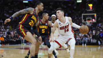 Apr 11, 2023; Miami, Florida, USA; Miami Heat guard Tyler Herro (14) drives to the basket as Atlanta Hawks forward John Collins (20) defends during the third quarter at Kaseya Center. Mandatory Credit: Sam Navarro-USA TODAY Sports
