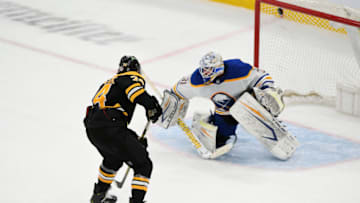 Apr 13, 2021; Boston, Massachusetts, USA; Boston Bruins left wing Jake DeBrusk (74) scores on Buffalo Sabres goaltender Dustin Tokarski (31) in a shootout at the TD Garden. Mandatory Credit: Brian Fluharty-USA TODAY Sports