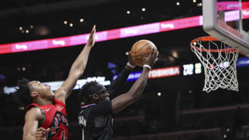 LOS ANGELES, CALIFORNIA - MARCH 16: Reggie Jackson #1 of the LA Clippers drives to the basket ahead of Scottie Barnes #4 of the Toronto Raptors (Photo by Meg Oliphant/Getty Images)