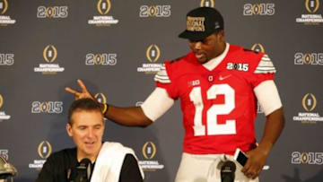 Jan 12, 2015; Arlington, TX, USA; Ohio State Buckeyes quarterback Cardale Jones (12) jokes around with Ohio State Buckeyes head coach Urban Meyer during a press conference after beating the Oregon Ducks in the 2015 CFP National Championship Game at AT&T Stadium. Mandatory Credit: Tim Heitman-USA TODAY Sports