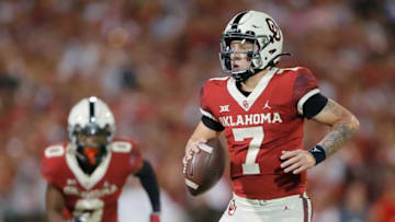 Oklahoma's Spencer Rattler (7) drops back to pass during a college football game between the University of Oklahoma Sooners (OU) and the West Virginia Mountaineers at Gaylord Family-Oklahoma Memorial Stadium in Norman, Okla., Saturday, Sept. 25, 2021. Oklahoma won 16-13.Lx12487